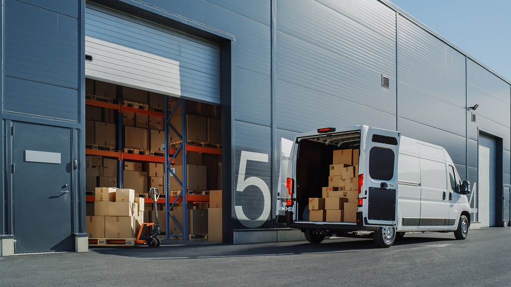 outside,of,logistics,warehouse,with,open,door,,delivery,van,loaded